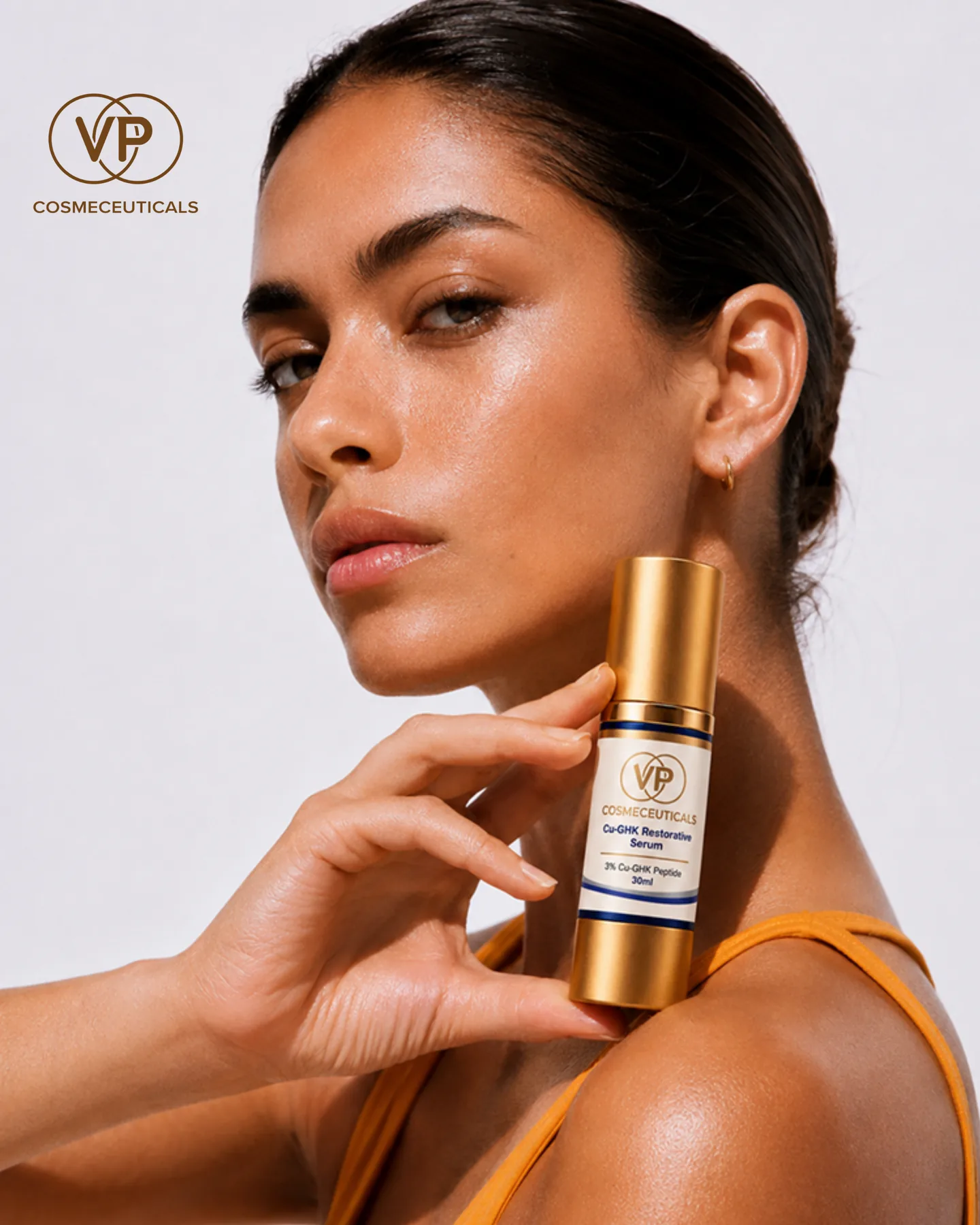 Model holding VP Cosmeceuticals Cu-GHK Restorative Serum with 3% Cu-GHK peptide